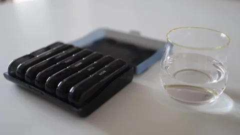 A well-organized pill container offers a simple way to ensure daily supplements  Stock Footage 301105954