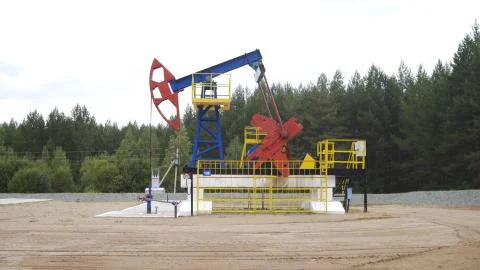 Well pump jack operating. Drilling rig extract crude oil. Oil mining machine Stock Photos