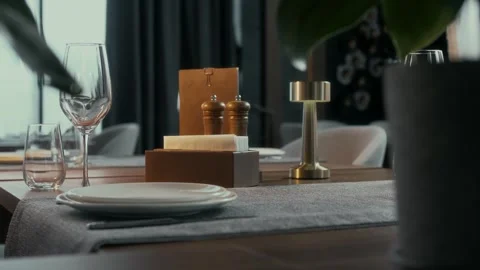 Well-served table made of natural wood in a luxury restaurant Stock Footage 314576897