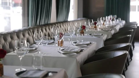 Well-set dining table in restaurant beside window with natural light. Plush Stock Footage 262274348