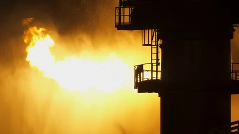 Well testing operation (flaring) of an oil and gas drilling rig at night Stock Footage 114740223