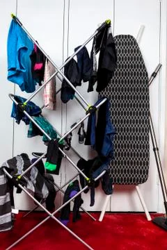 Well worn looking clothes drying on a cloths horse Foto stock
