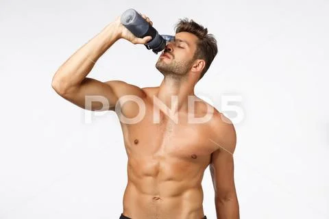 Wellbeing, bodybuilding and fitness concept. Handsome, sexy young bearded Stock Photos