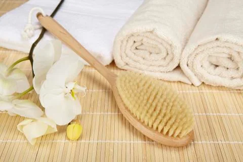 Wellness - bath brush, folded and rolled towels Stock Photos