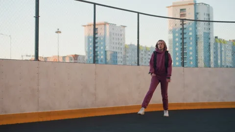 Wellness Devotee Jogging Round Urban Sports Court Surrounded by Modern Towers Stock Footage 316659229
