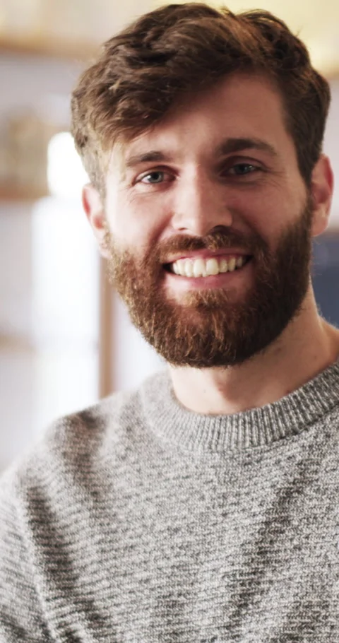 Wellness, face and man in home with smile, positive attitude and chill in Stock Footage 330081789