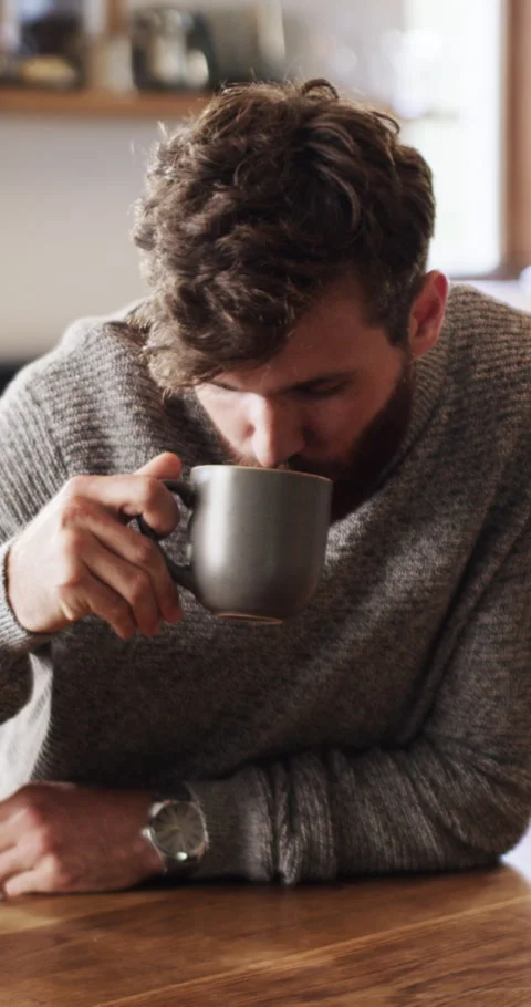 Wellness, face and man in kitchen with coffee, positive attitude or chill in Stock Footage 329764097