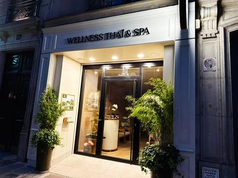 Wellness Thai  Spa storefront in Paris, France illuminated at night with ba.. Stock Photos