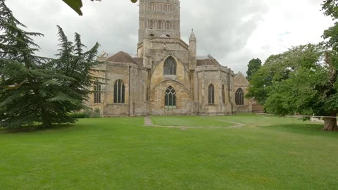 Wells Cathedral Gothic stone facade with lawn and trees in England Stock Footage 333047803