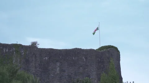 Welsh Flag Flying over a Castle Stock Footage 293094927