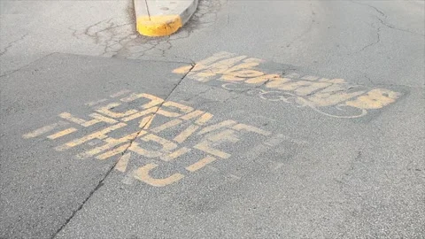 Wendys drive thru written caption on pavement in yellow with logo at drive thru Stock Footage 249760524