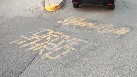 Wendys drive thru written caption on pavement in yellow with logo at drive thru Stock Footage 249760634