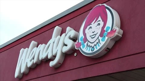 Wendys restaurant logo on building store exterior outside in summer Stock Footage 249760165