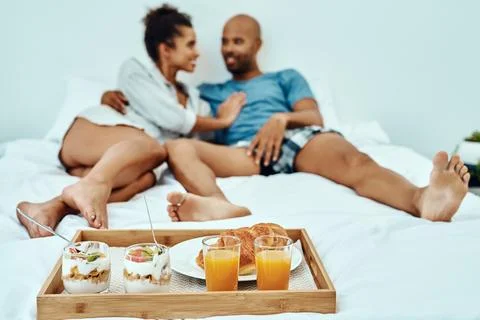 Were doing everything in bed, even breakfast. a couple having breakfast in bed. Fotos Stock
