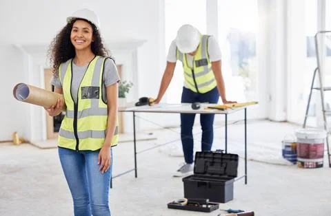 Were doing what we do best. an attractive young contractor standing inside and Fotos de archivo