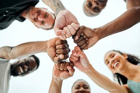 Were here to uplift one another. Shot of a group of friends fist bumping one Stock Photos