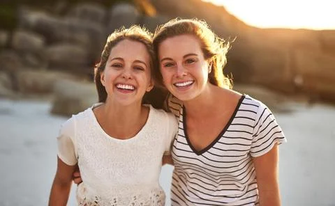 Were inseparable. two friends spending the day at the beach. Stock Photos