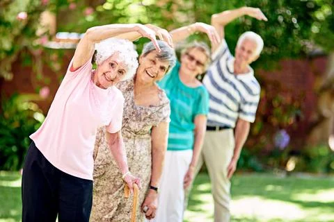 Were not young but we live like it. a group of smiling seniors exercising Stock Photos
