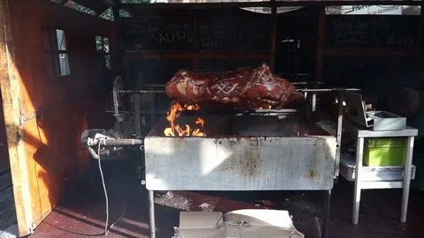 Wernigerode, Germany - June 17, 2017: Pigs are roasting on a spit. Roasting pig Stock Footage 82464741