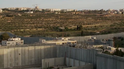 West Bank separation barrier wall at Bethlehem, wide shot pan left Stock Footage 56507455