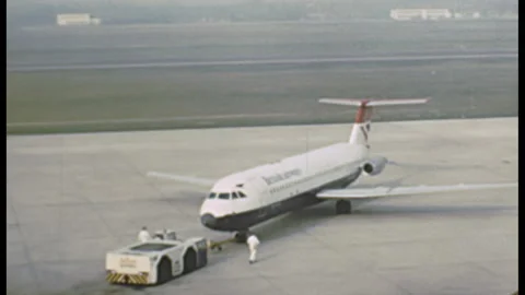 West Berlin - 1977: pushback tractor moves a aircraft at Tegel Airport Stock Footage 144834128