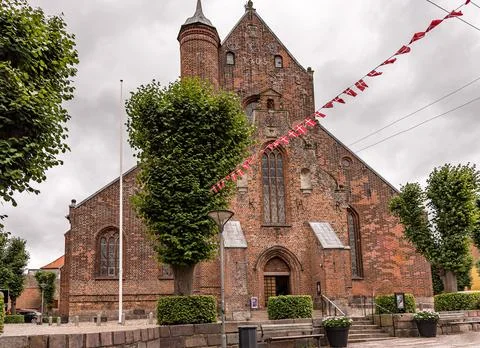West facade and entry of Haderslev cathedral, decorated with danish flags Stock Photos