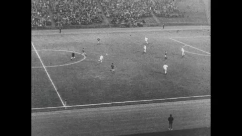 West Germany 1960s: Crowd waves Hamburger SV flags. Players on a soccer pitch. Stock Footage 243366111