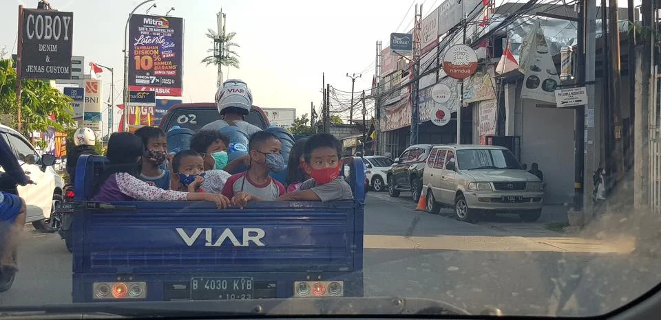 West Java in April 2019. A group of children ride a tricycle that has a vesse Stock Photos