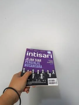 West Java, August 2022. A hand is holding an Intisari magazines December 2021 Stock Photos