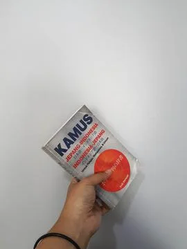 West Java, August 2022. A hand is holding a Japanese-Indonesian dictionary fo Stock Photos