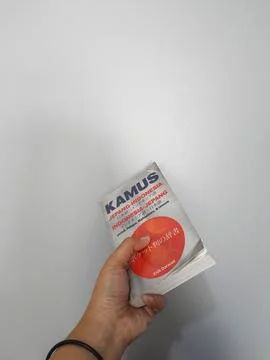 West Java, August 2022. A hand is holding a Japanese-Indonesian dictionary fo Stock-Fotos