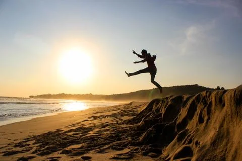 West Java, Indonesia - April 15, 1017: Silhouette of a boy on the beach jum.. Stock Photos