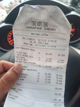 West Java, Indonesia in April 2022. A hand is holding a drink receipt at a .. Fotos de archivo