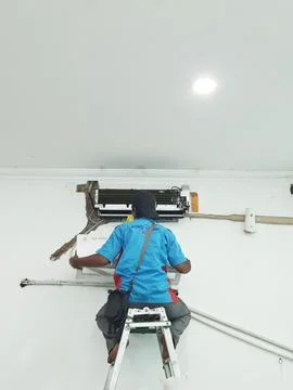 West Java, Indonesia in July 2022. A technician is repairing and cleaning a b Stock Photos