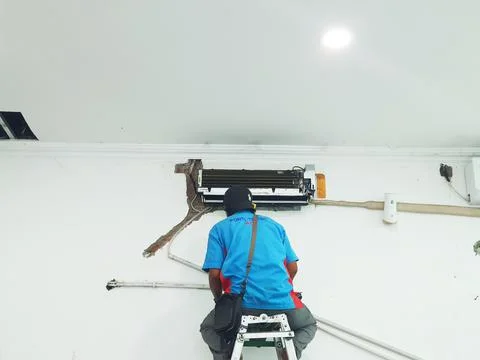 West Java, Indonesia in July 2022. A technician is repairing and cleaning a b Stock Photos