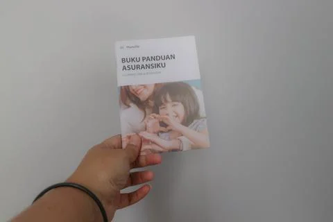 West Java, Indonesia on July 2022. A hand holding Manulife's Insurance Hand.. Stock-Fotos