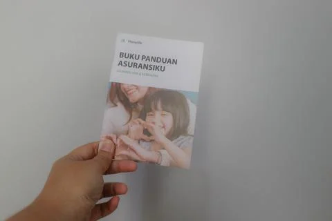 West Java, Indonesia on July 2022. A hand holding Manulife's Insurance Hand.. Stock-Fotos