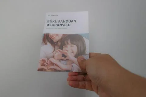 West Java, Indonesia on July 2022. A hand holding Manulife's Insurance Hand.. Stock-Fotos