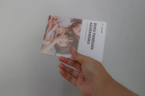 West Java, Indonesia on July 2022. A hand holding Manulife's Insurance Hand.. Stock-Fotos