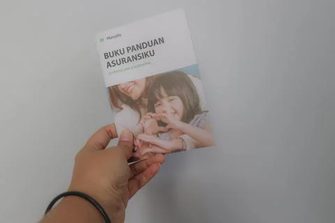 West Java, Indonesia on July 2022. A hand holding Manulife's Insurance Hand.. Stock-Fotos