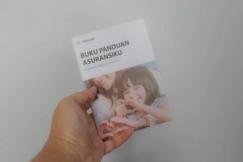 West Java, Indonesia on July 2022. A hand holding Manulife's Insurance Hand.. Stock-Fotos