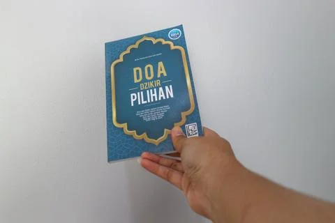 West Java, Indonesia on July 2022. A hand is holding a book of selected pra.. Stock Photos