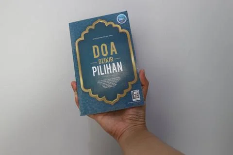 West Java, Indonesia on July 2022. A hand is holding a book of selected pra.. Stock Photos
