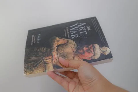 West Java, Indonesia on July 2022. A hand is holding a book called The Art .. Stock-Fotos