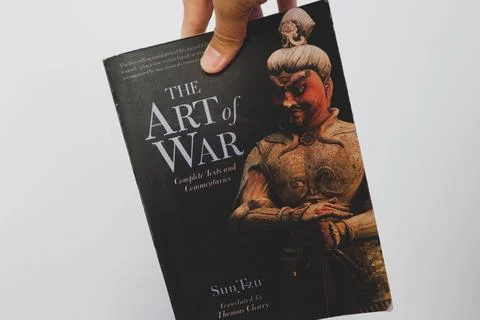 West Java, Indonesia on July 2022. A hand is holding a book called The Art .. Stock Photos