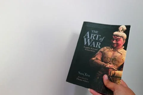 West Java, Indonesia on July 2022. A hand is holding a book called The Art .. Stock Photos