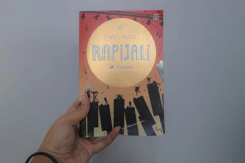 West Java, Indonesia on July 2022. A hand is holding a novel called Rapijal.. Stock Photos