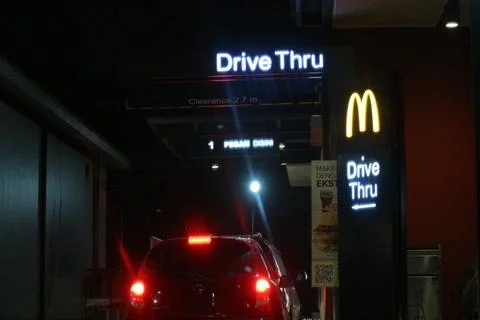 West Java, Indonesia on July 2022. Glowing McDonalds restaurant sign agains.. 库存照片