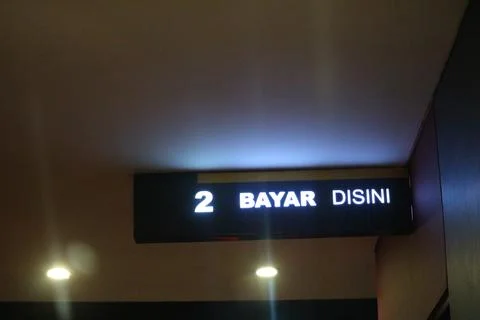 West Java, Indonesia on July 2022. Glowing McDonalds restaurant sign agains.. 库存照片