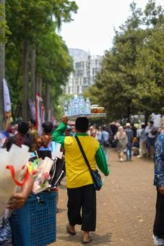 West Java, Indonesia- May, 05, 2024: Drink seller is carrying his wares on .. Stock Photos